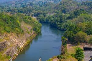 An aerial view of the dam-caused canal in Thailand's national park, with a mountain the background. Bird eye view. photo