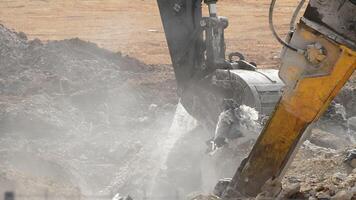 Excavator hammer and excavator with debris in the demolition of a building video