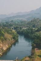 An aerial view of the dam-caused canal in Thailand's national park, with a mountain the background. Bird eye view. photo