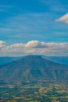 The stunning view of Thailand's Fuji in Forest Park from a tourist's standpoint as they go down a hill with background of blue sky, Rainforest, Thailand. Bird's eye view. Aerial view. photo