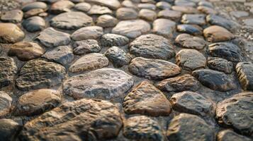 A close up of a stone wall made of rocks, displaying a rugged texture photo