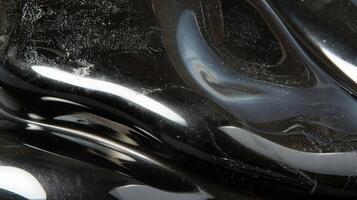 Reflective Black and Silver Polished Stone with Smooth Texture - Perfect for Design, Poster, Card, and Print Projects photo