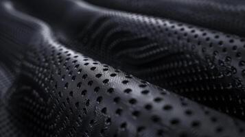 Macro View of Textured Black Synthetic Rubber Surface with Perforations for Design, Print, and Innovation Concepts photo