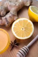 A lemon, honey and ginger on the wooden background. Close-up. Selective focus. photo