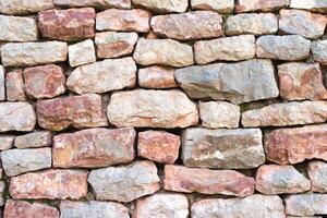Texture of a stone wall. Natural and abstract background. Part of a building wall. Background for design. photo
