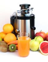 A glass of fresh fruit juice, fruits and a modern juicer extractor on the table. Healthy fruit and vegetable juices at home. Selective focus. Close-up. photo