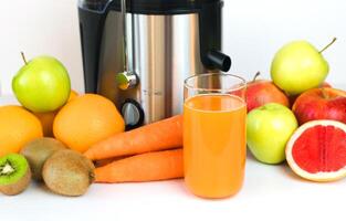 A glass of fresh juice from fruits and vegetables on the table. Healthy fruit and vegetable juices. Selective focus. Close-up. photo