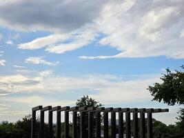 sky and the clouds have trees and views of the city as a component. photo