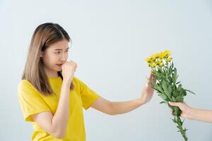 Pollen Allergies, asian young woman sneezing in a handkerchief or blowing in a wipe, allergic to wild spring flowers or blossoms during spring. allergic reaction, respiratory system problems photo