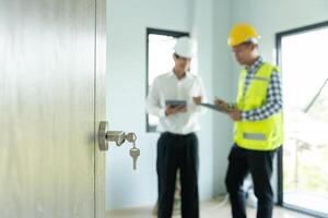 inspector engineer and owner project is inspecting construction and quality assurance new house. Engineers or architects or contactor work to build the house before handing it over to the homeowner photo