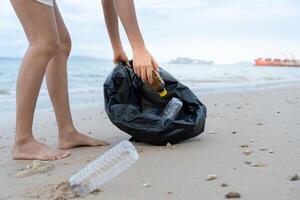 Save water. Volunteer pick up trash garbage at the beach and plastic bottles are difficult decompose prevent harm aquatic life. Earth, Environment, Greening planet, reduce global warming, Save world photo