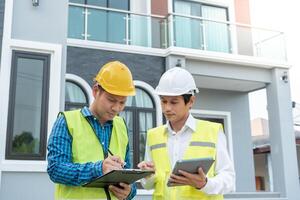 inspector engineer and owner project is inspecting construction and quality assurance new house. Engineers or architects or contactor work to build the house before handing it over to the homeowner photo