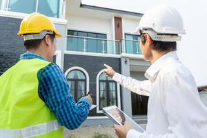 inspector engineer and owner project is inspecting construction and quality assurance new house. Engineers or architects or contactor work to build the house before handing it over to the homeowner photo