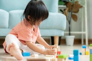 Happy Asia children play and learn toy blocks.family is happy and excited in the house. daughter having fun spending time, Activity, development, IQ, EQ, meditation, brain, muscles, essential skills. photo