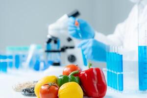 Scientist check chemical food residues in laboratory. Control experts inspect quality of fruits, vegetables. lab, hazards, ROHs, find prohibited substances, contaminate, Microscope, Microbiologist photo