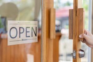show sign open on the first day of business. guarantees safety, cleanliness, open the coffee shop. open for New normal. Small business, welcome, restaurant, home made, family photo