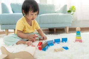 Happy Asia children play and learn toy blocks.family is happy and excited in the house. daughter having fun spending time, Activity, development, IQ, EQ, meditation, brain, muscles, essential skills. photo
