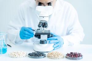 Scientist analyze biochemical samples in advanced scientific laboratory. Medical professional use microscope look microbiological developmental of viral. Biotechnology research in science lab. photo