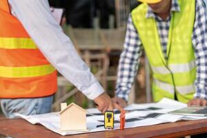 Engineers use blueprint check construction on site. Contractor and inspector inspection construction during project.civil Forman check quality assurance. Audit, inspect, quality control. photo