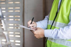 inspector or engineer is inspecting construction and quality assurance new house using a checklist. Engineers or architects or contactor work to build the house before handing it over to the homeowner photo