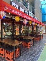 Afternoon Street Scene with City Cafe and Restaurant Signs in Japanese town, Chonburi, Thailand photo