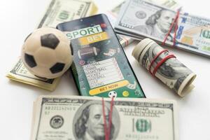 tablet pc with app for sport bets, on top of stacks of banknotes, white background, concept of online bets 3d render photo