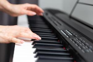 keyboard and hands playing the piano photo