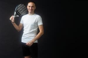 Padel Tennis Player with Racket in Hands. Paddle tennis, on a black background. photo