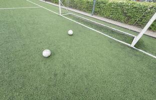 Green grass and white border lines on football ground. Soccer field on artificial turf. Artificial green grass texture. Artificial football field in an open stadium photo