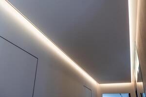 Fragment of a stretch ceiling with the hidden LED illumination photo