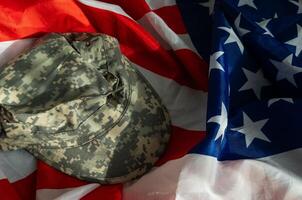 US Army helmet and dog tag on US flag background photo