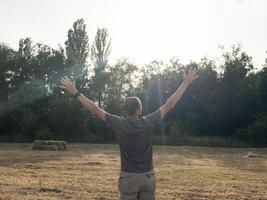 A Man Looking At Sky With Arms Wide Open photo