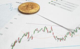 Bitcoin coin is on background of stock chart photo