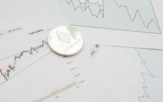 Bitcoin coin is on background of stock chart photo