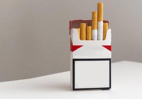 Open pack of cigarettes and a cigarette on a white background. photo