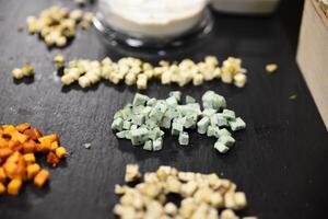 Cheese arranged on a dark table. Different sorts of cheese. Various types of cheese photo