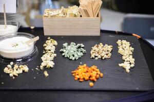 Cheese arranged on a dark table. Different sorts of cheese. Various types of cheese photo