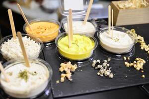 Cheese arranged on a dark table. Different sorts of cheese. Various types of cheese photo