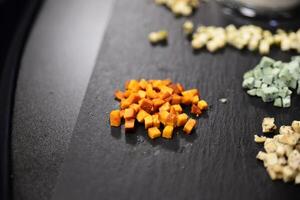 Cheese arranged on a dark table. Different sorts of cheese. Various types of cheese photo