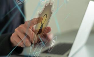 Businessman use a laptop to login by password with virtual screen of padlock, security of private. Technology to security protection of business, and privacy photo