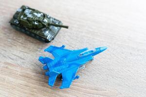 The image shows models of tanks and fighter jets on a white background, close up. photo
