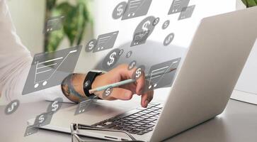 Online shopping and e-commerce concept. Young man using laptop computer with shopping cart icon, order in online store, shopping on internet, concept on virtual screen with hands typing on keyboard photo
