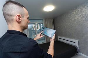 Man using smart home security system control panel photo