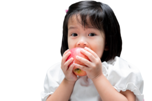 Smiling child enjoying a fresh red apple. A cute girl is happily biting an apple. Children eat fruit to stay healthy and strong. Isolated background. png