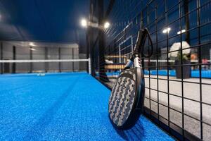 paddle tennis racket and balls on the blue paddle court photo