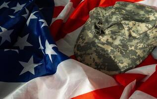 US Army helmet and dog tag on US flag background photo