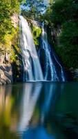 Rushing waterfall with sunlit glow, reflective pool, vibrant greenery in peaceful setting Vertical Mobile Wallpaper photo