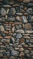 Aged stone wall with irregular shapes in grays, browns, whites oozes history and character Vertical Mobile Wallpaper photo