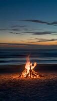 Twilight transforms beach into serene scene with blazing bonfire casting warm light on sand Vertical Mobile Wallpaper photo