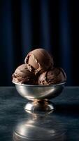 Decadent chocolate ice cream in a shiny bowl on a dark surface Vertical Mobile Wallpaper photo